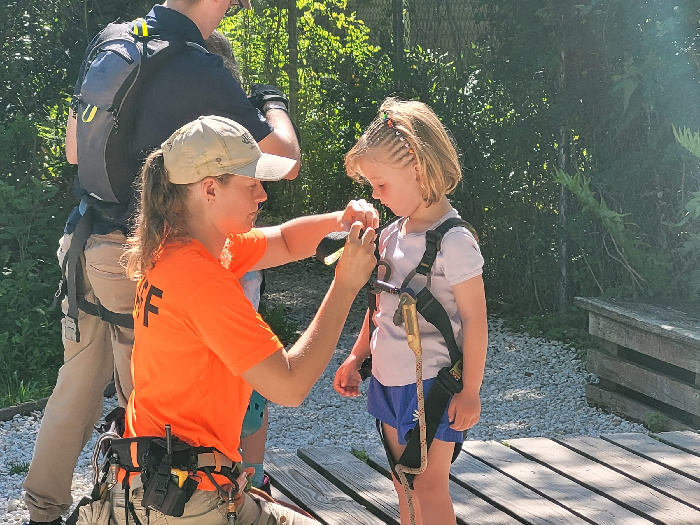 Rabbit getting harnessed up for the Treetop Trek Chutes course at Brevard Zoo