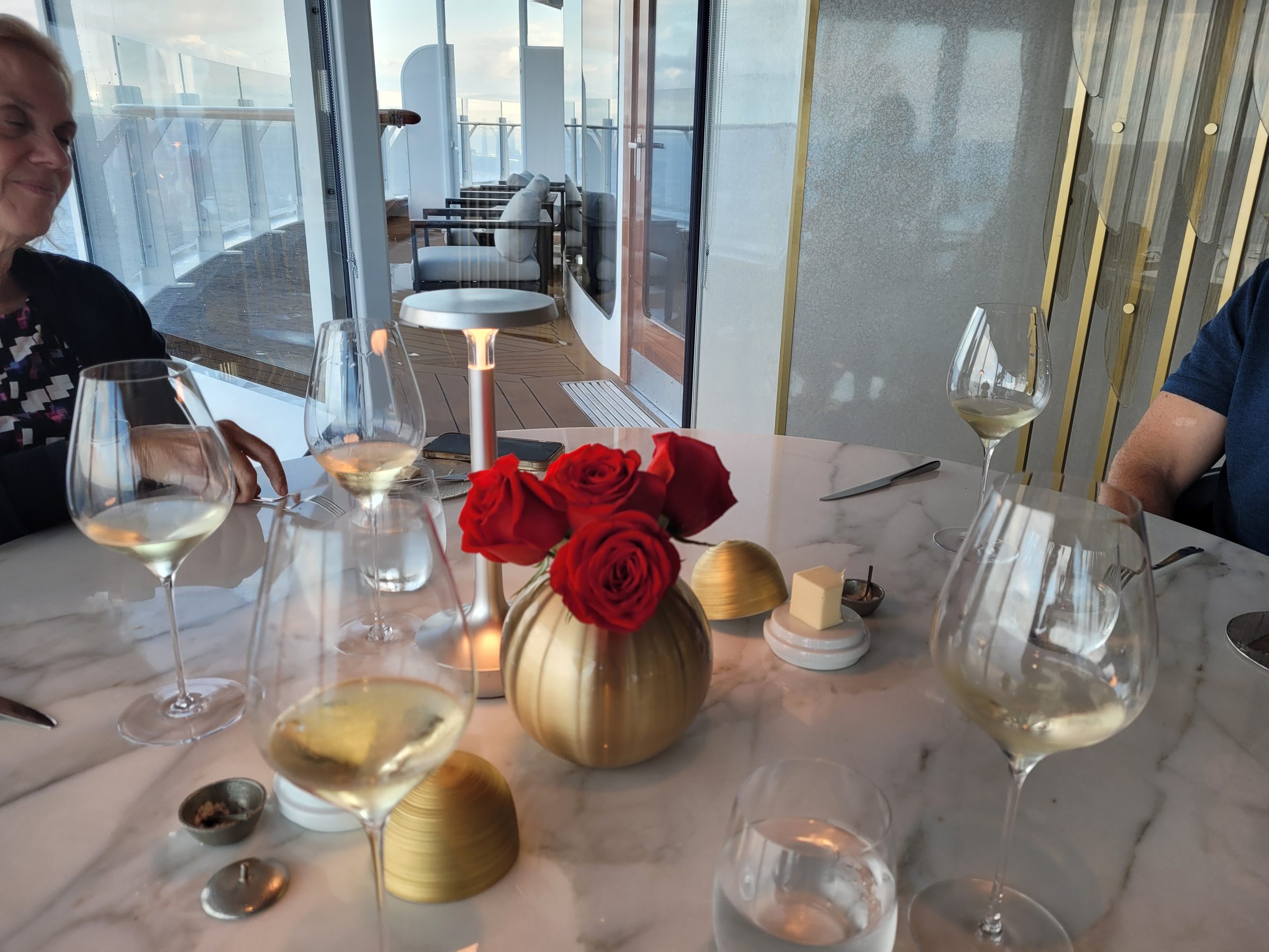 The dinner table at Enchanté, wine and roses at dusk