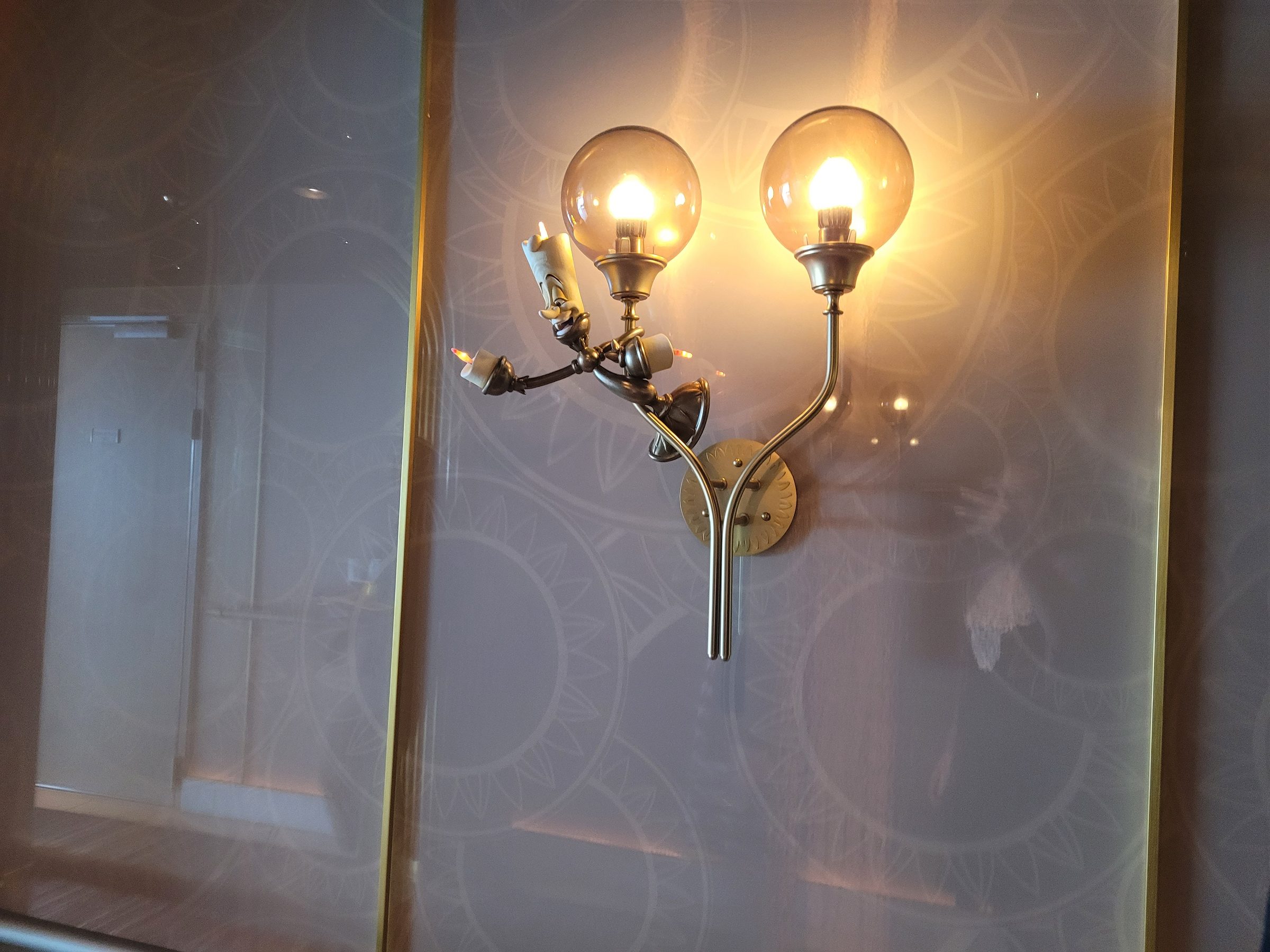 Lumière wall sconce in Enchanté — the restaurant is inspired by the character